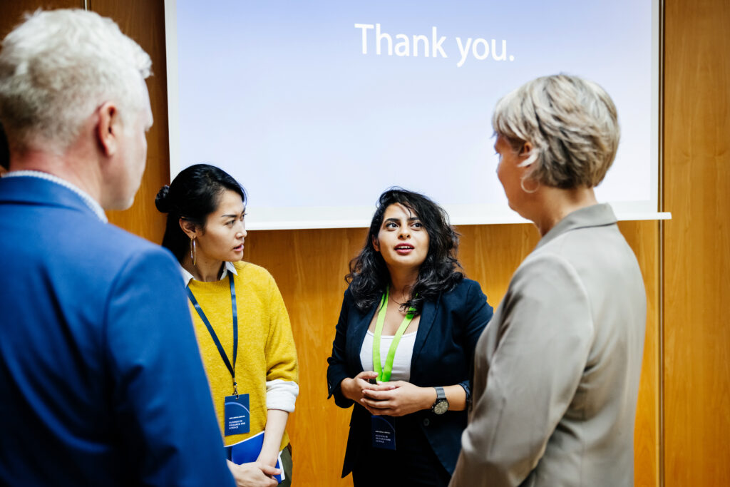 Group Of Business People Talking At A Conference